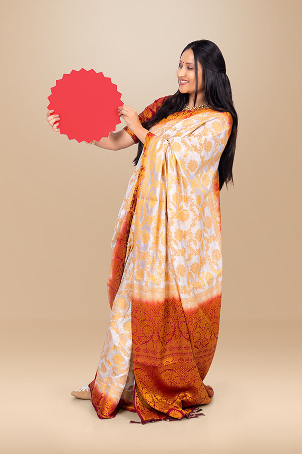 Indian woman presenting red promotional badge in festive ethnic attire
