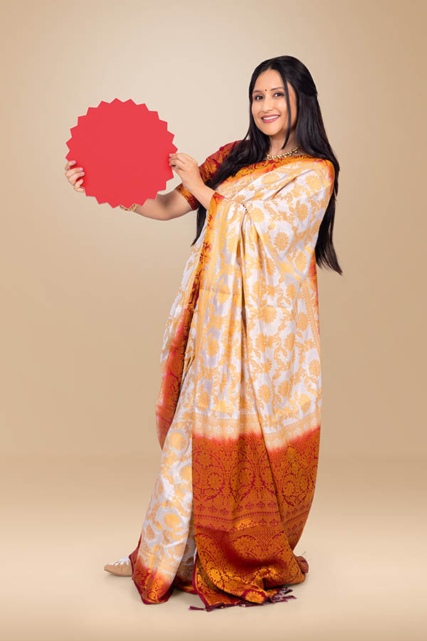 Smiling Indian woman displaying red sale badge for festive offers
