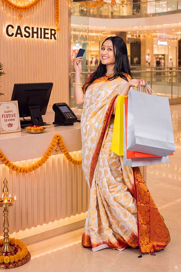 Indian woman making festive card payment after shopping