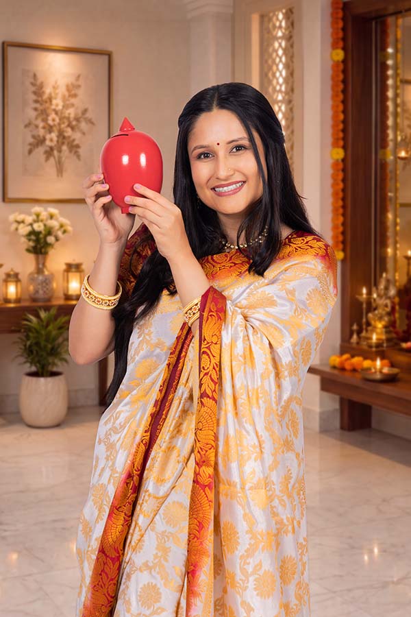 Indian woman holding festive savings pot for financial prosperity