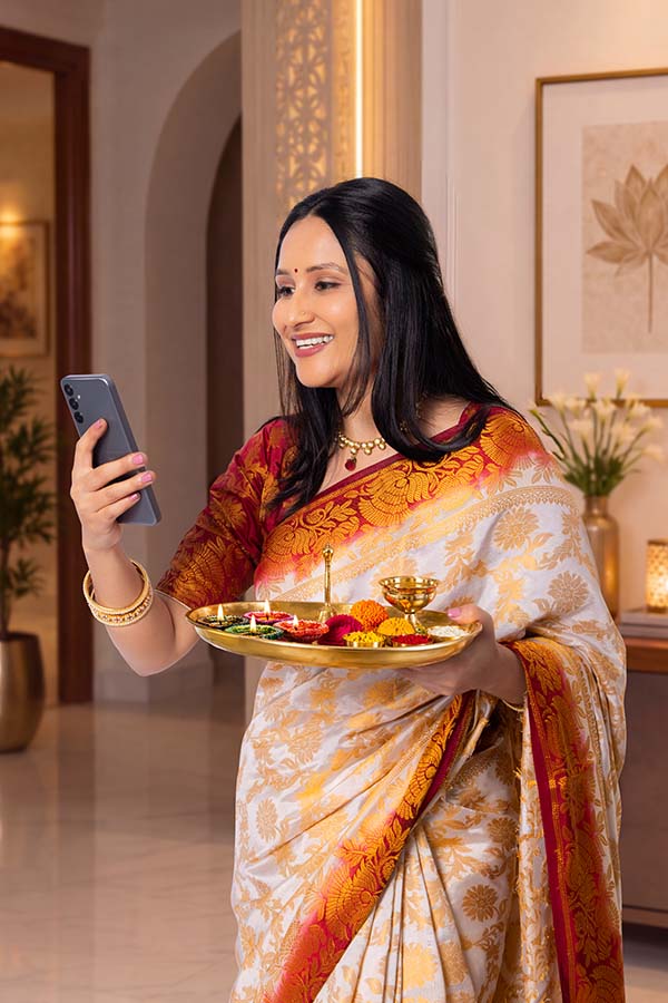 Indian woman performing festive video call with puja thali