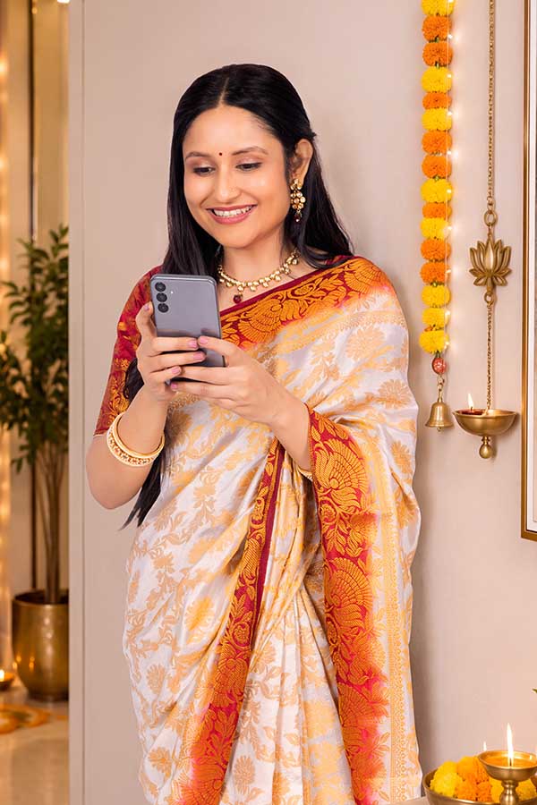 Indian woman using smartphone during festive celebration