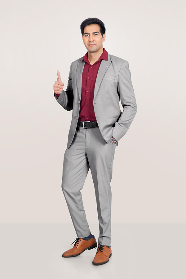Indian businessman in formal suit giving thumbs up