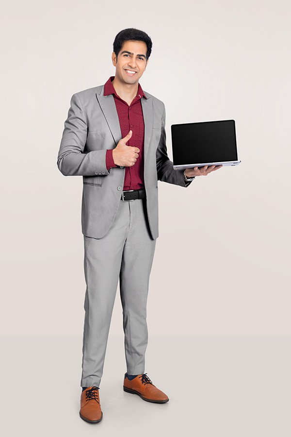 Indian businessman presenting laptop with thumbs up gesture