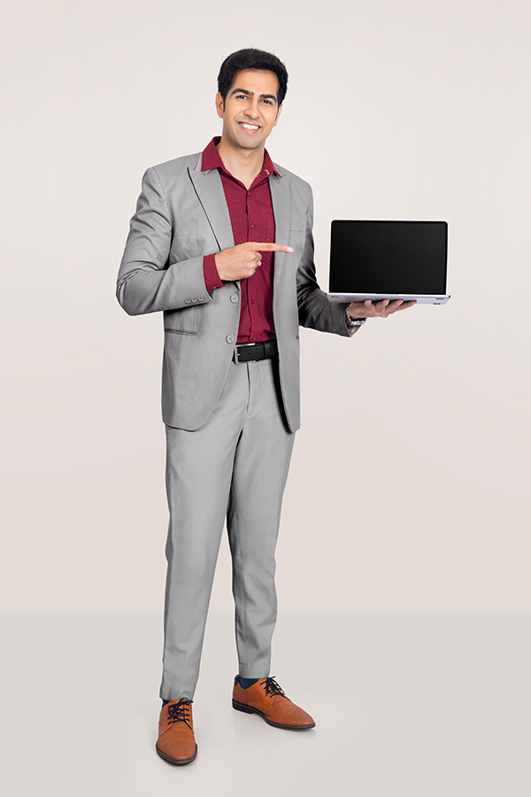 Indian businessman pointing at laptop screen in formal suit