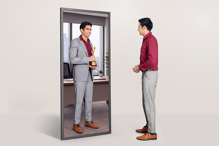 Indian businessman viewing professional reflection in mirror