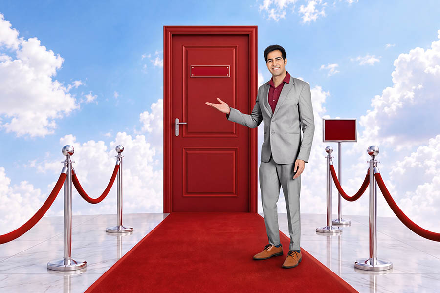 Indian businessman presenting opportunity through red door