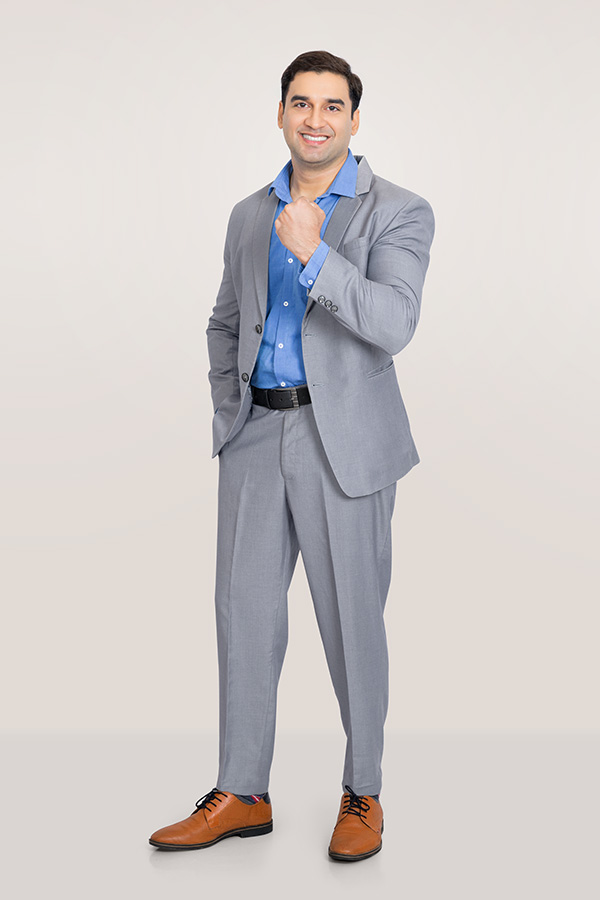 Indian businessman making confident fist gesture in formal suit