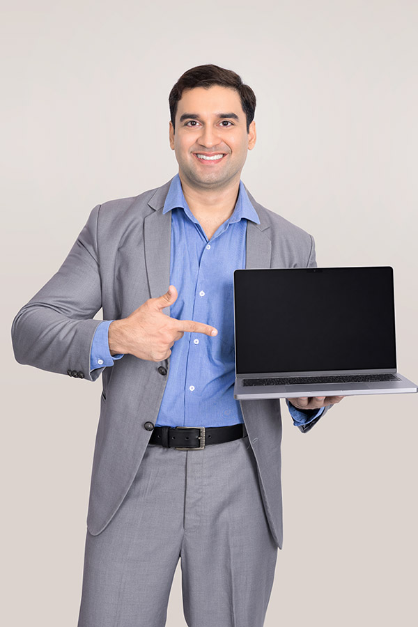 Indian businessman presenting laptop for business technology concept
