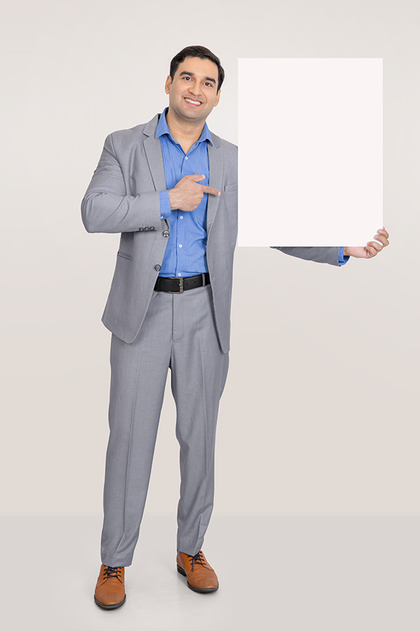 Indian businessman presenting blank signboard for advertising message