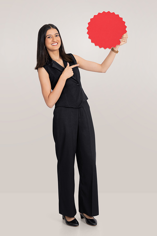 Indian businesswoman presenting red badge for promotional campaign