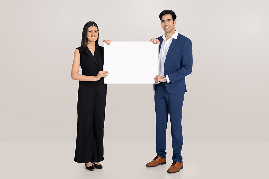 Indian business professionals holding blank signboard for corporate message