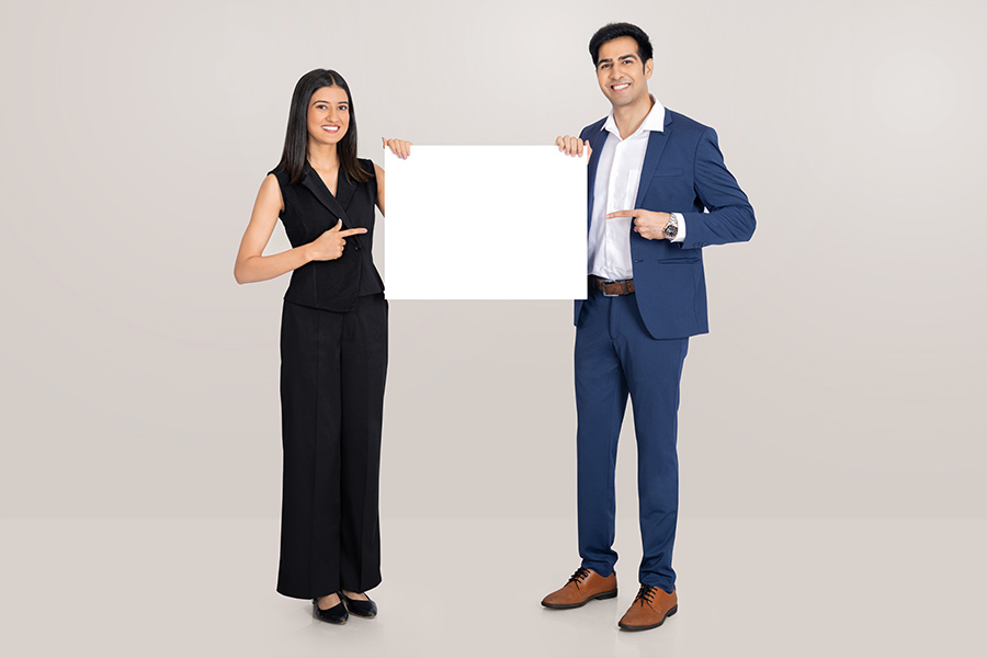 Indian business professionals presenting blank signboard for corporate advertising