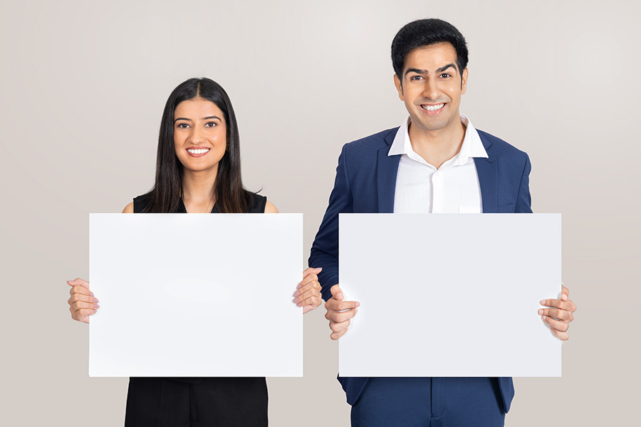 Indian business professionals presenting blank boards for corporate communication