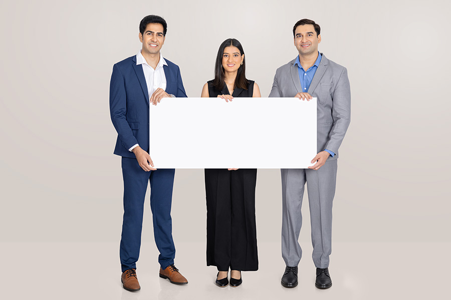 Indian business team holding blank board for corporate advertising message