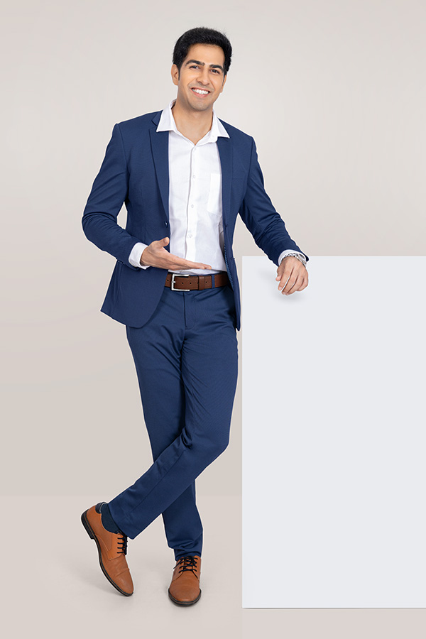 Indian businessman presenting blank board with open palm gesture for advertising
