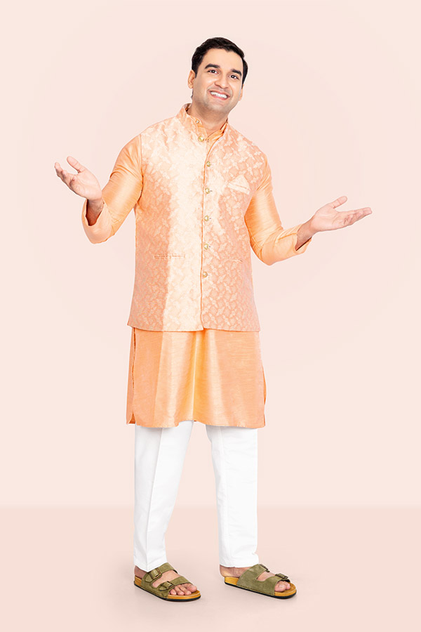 Smiling Indian man welcoming customers with open arms