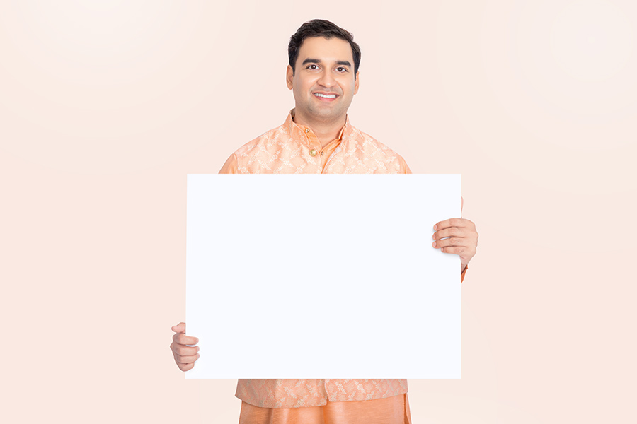Indian man holding a blank white promotional signboard
