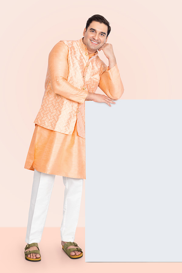 Indian man leaning on a blank promotional panel