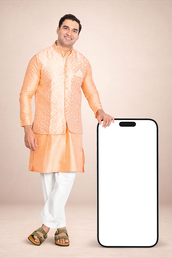 Indian man standing beside a large blank smartphone mockup