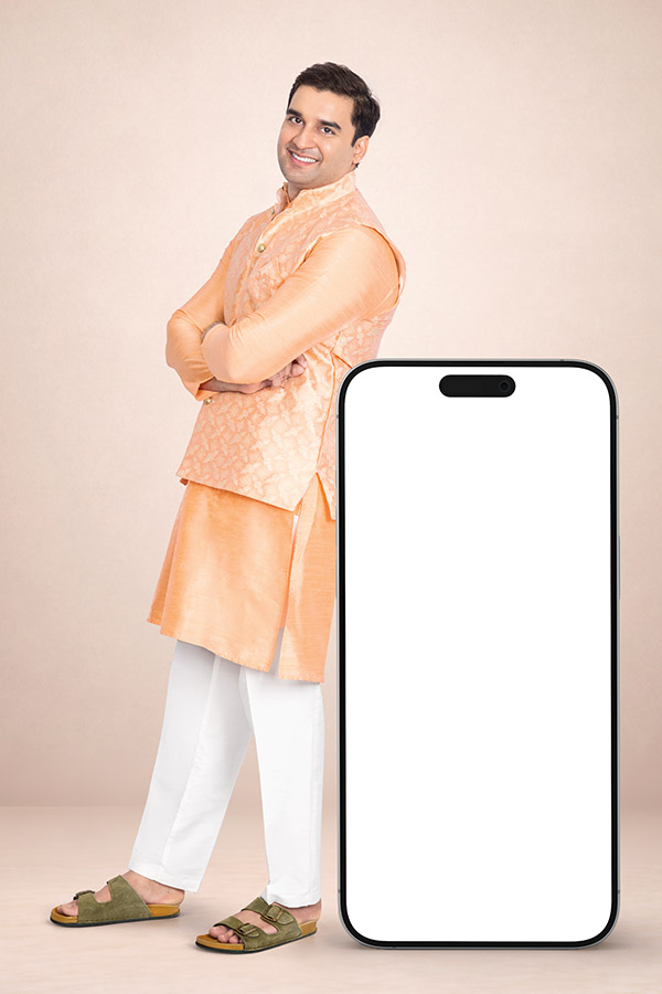 Indian man posing beside an oversized blank smartphone screen