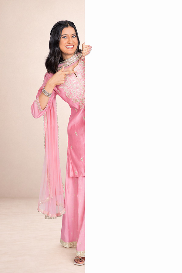 Indian woman pointing towards a large blank white advertising panel