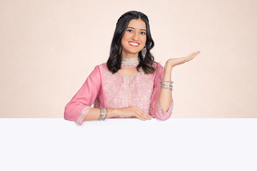Indian woman presenting a blank banner with an open palm